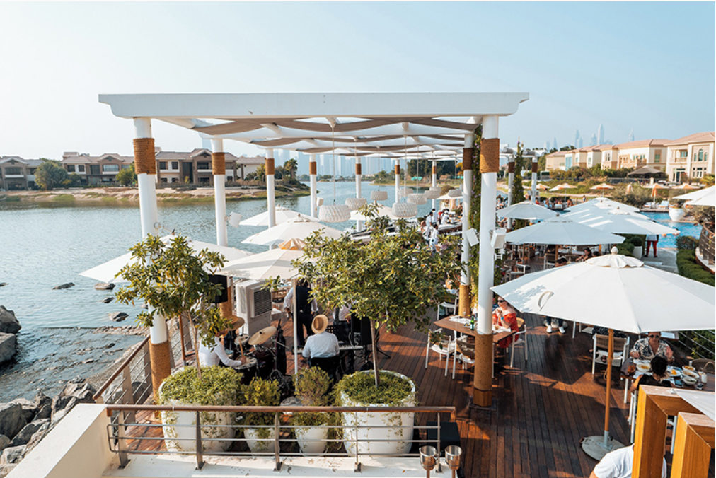 Terrace dining at Isola Dubai in Jumeirah Islands overlooking the lake